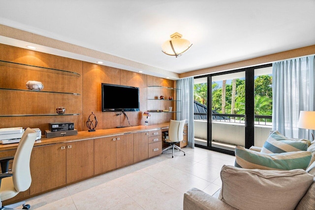 home office with built in desk and light tile patterned flooring