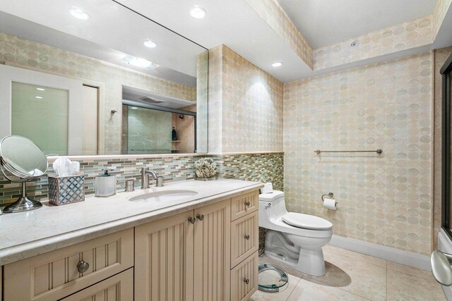 1800 S Ocean Blvd Unit 2A, Boca Raton, FL 33432 - bathroom featuring toilet, vanity, an enclosed shower, tile patterned flooring, and backsplash