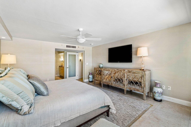 tiled bedroom featuring ceiling fan and connected bathroom