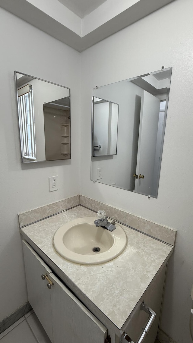 bathroom with tile patterned flooring and vanity