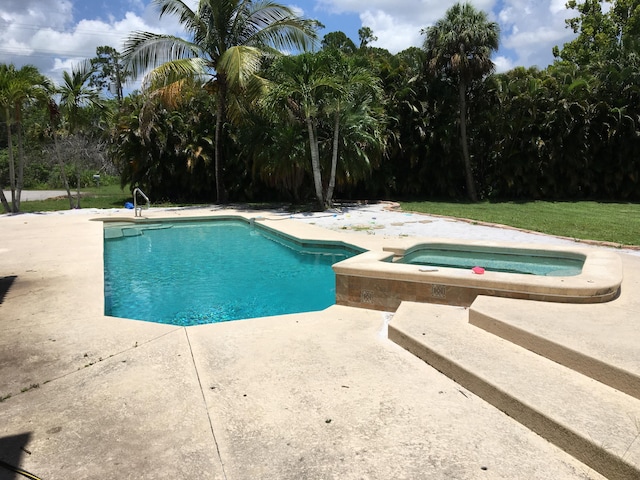 view of pool with an in ground hot tub and a patio