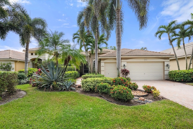 view of front of property featuring a garage and a front lawn