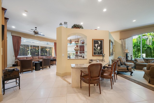 dining space with light tile patterned flooring and ceiling fan