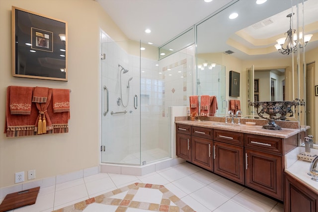 bathroom with vanity, an enclosed shower, an inviting chandelier, and tile patterned floors