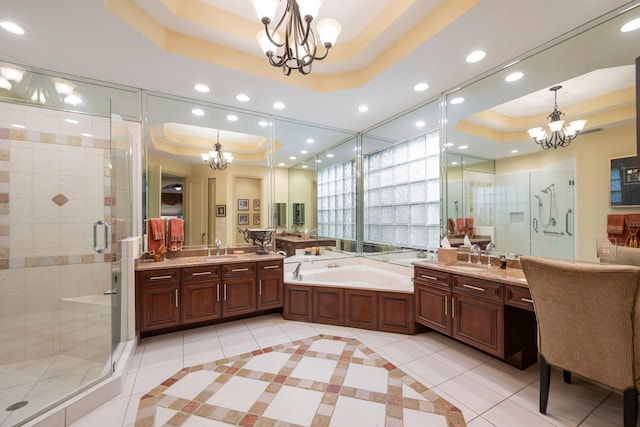 bathroom with vanity, plus walk in shower, tile patterned floors, and a raised ceiling