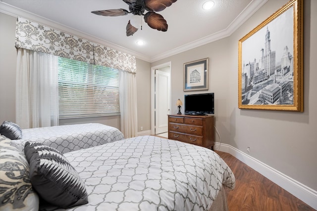 bedroom featuring ornamental molding, hardwood / wood-style floors, and ceiling fan