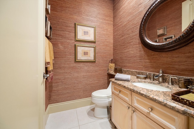 bathroom featuring tile patterned flooring, vanity, and toilet