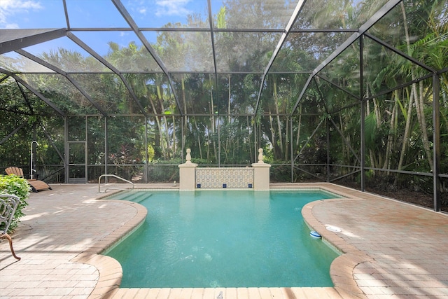 view of swimming pool with a lanai and a patio