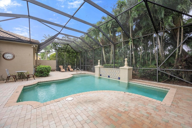 view of swimming pool with a lanai and a patio