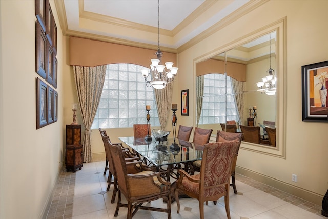 tiled dining room with crown molding, a notable chandelier, and a raised ceiling