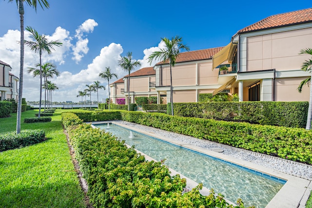 view of pool featuring a yard