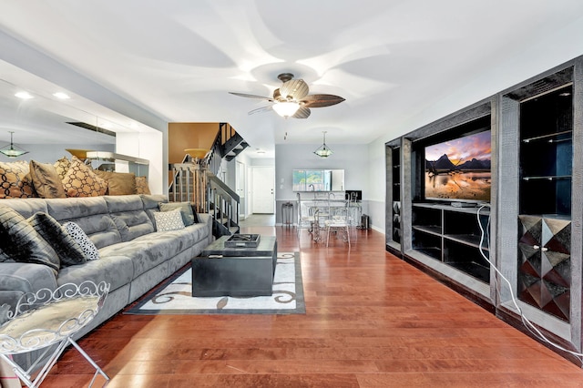 living room featuring hardwood / wood-style floors and ceiling fan