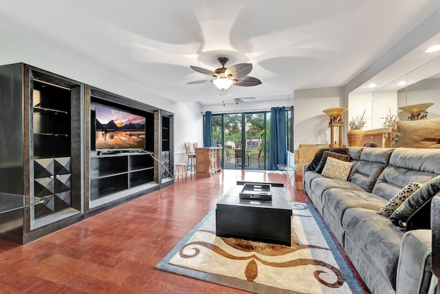 living room featuring ceiling fan and wood-type flooring