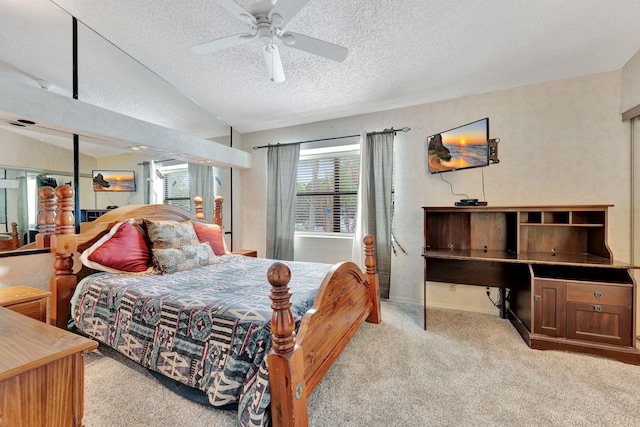 carpeted bedroom featuring lofted ceiling, a textured ceiling, and ceiling fan