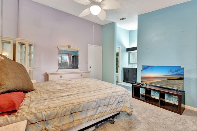 carpeted bedroom with a textured ceiling, a towering ceiling, ceiling fan, and connected bathroom