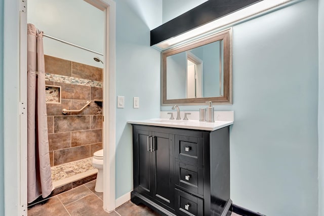 bathroom featuring toilet, vanity, a shower with shower curtain, and tile patterned floors