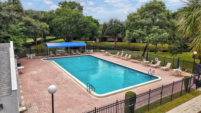 view of swimming pool with a lawn and a patio