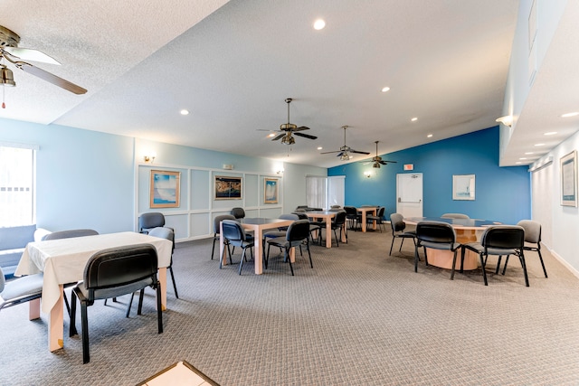 dining area with vaulted ceiling and carpet flooring