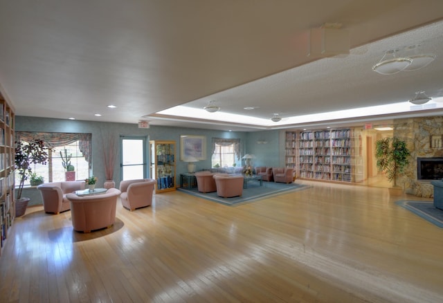 living room with light wood-type flooring and a fireplace