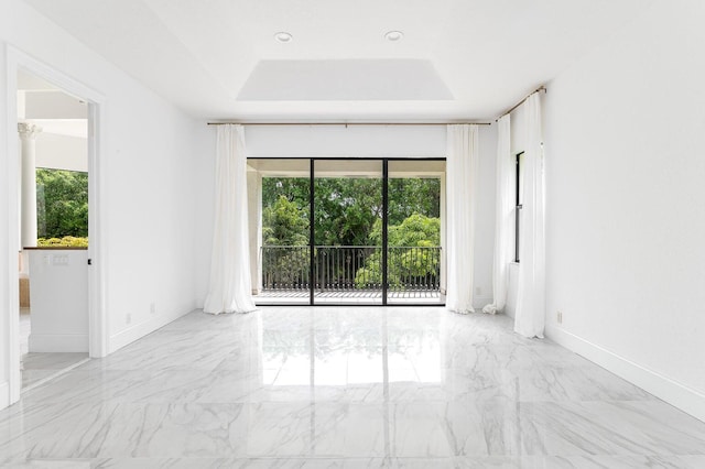 unfurnished room featuring a tray ceiling