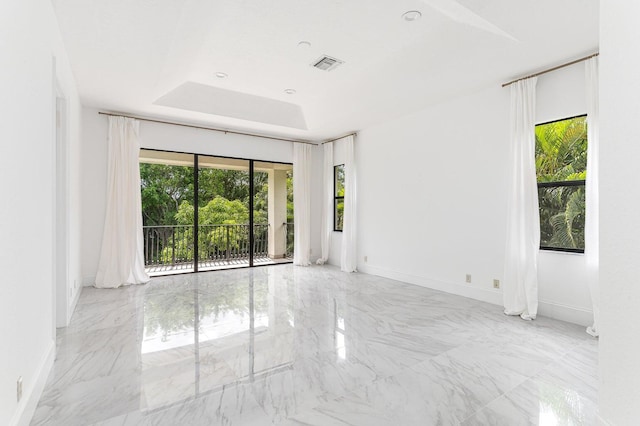 spare room with a tray ceiling