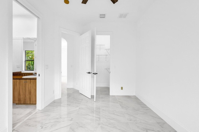 empty room featuring ceiling fan and sink