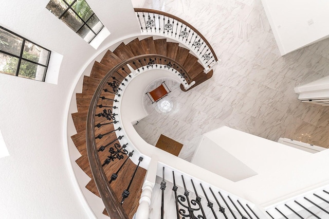 staircase featuring tile walls