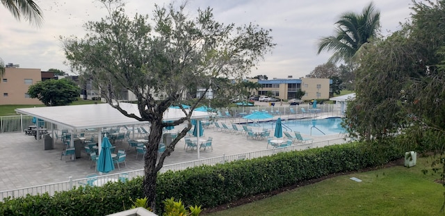 view of pool featuring a patio area and a yard