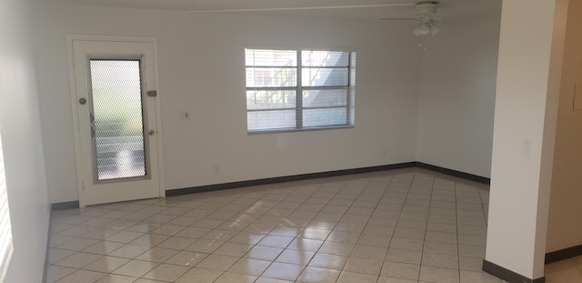 unfurnished room with light tile patterned floors and ceiling fan