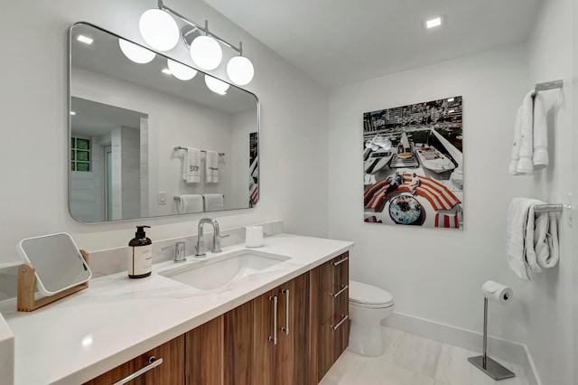 bathroom with walk in shower, vanity, and toilet