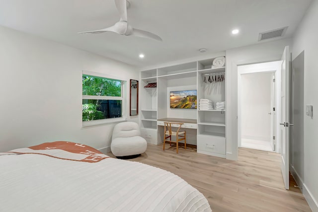 bedroom featuring a closet, light hardwood / wood-style floors, and ceiling fan