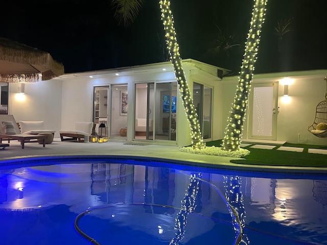 pool at night with a patio