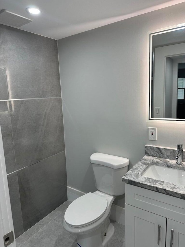 bathroom featuring tile patterned floors, vanity, and toilet