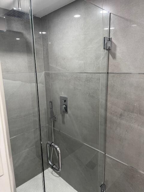 bathroom featuring a shower with shower door