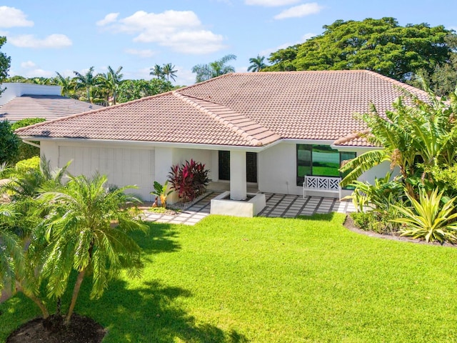 rear view of house with a lawn and a patio area