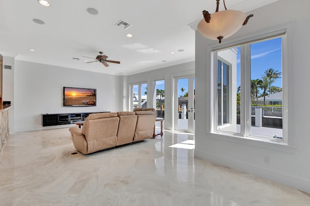 living room with ceiling fan and ornamental molding