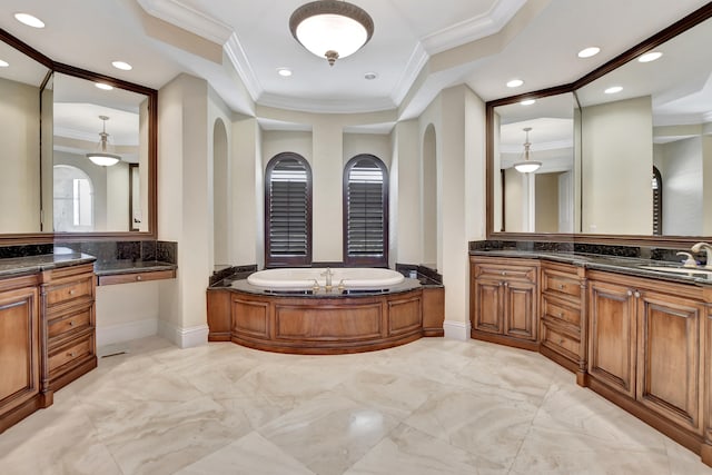 bathroom featuring ornamental molding, a washtub, and vanity