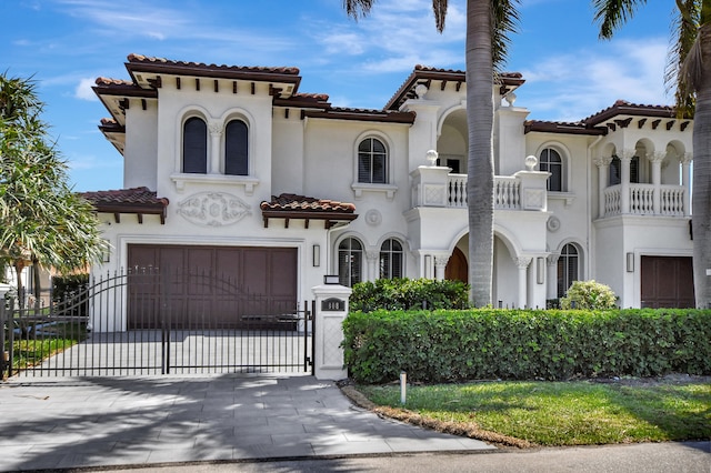 mediterranean / spanish house featuring a garage and a balcony