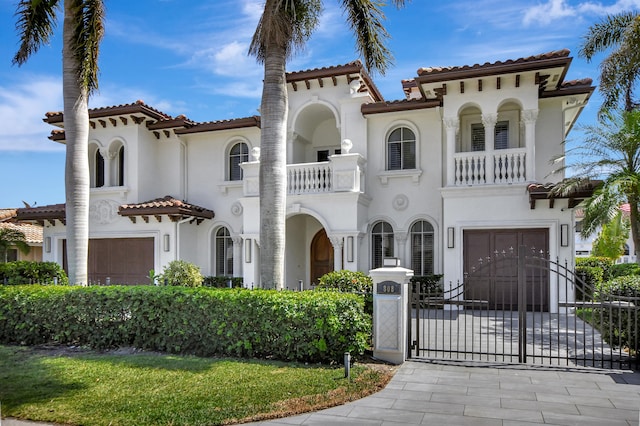 mediterranean / spanish-style house featuring a garage and a balcony