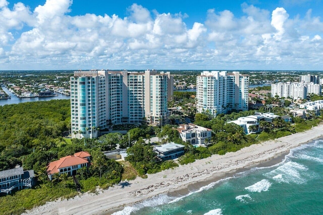 birds eye view of property with a view of the beach and a water view