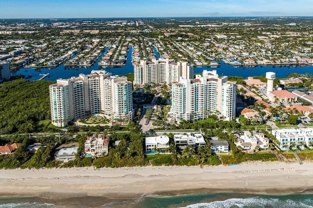 birds eye view of property featuring a water view and a beach view