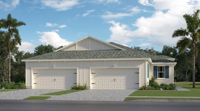 view of front of house featuring a front yard and a garage