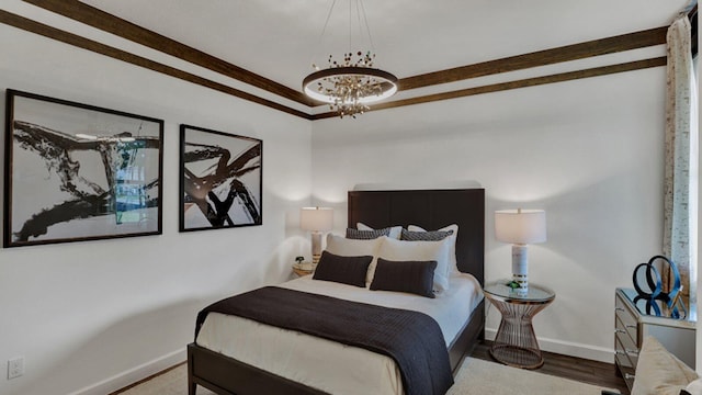 bedroom featuring wood-type flooring, an inviting chandelier, and ornamental molding