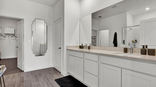 bathroom featuring vanity, wood-type flooring, and an enclosed shower