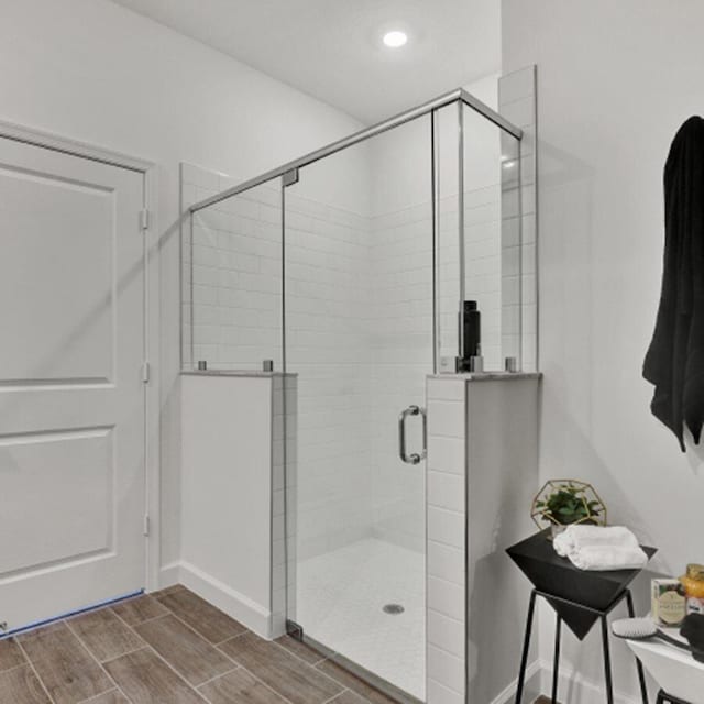 bathroom featuring a shower with shower door