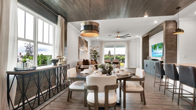 dining area featuring crown molding, hardwood / wood-style flooring, and wooden ceiling