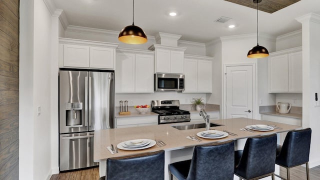 kitchen featuring white cabinetry, appliances with stainless steel finishes, sink, and a kitchen island with sink