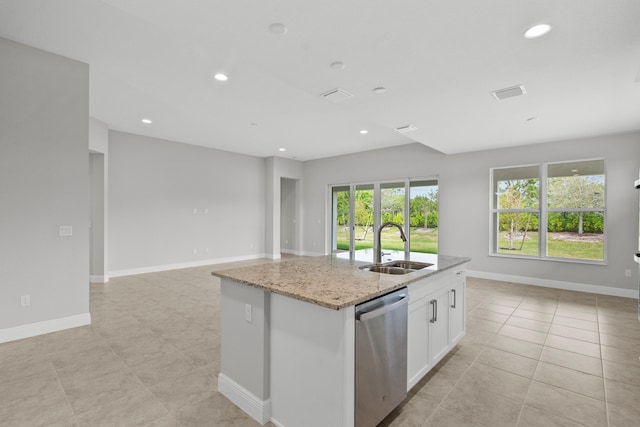 kitchen with dishwasher, a kitchen island with sink, sink, light stone countertops, and white cabinetry