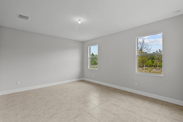 unfurnished room with light tile patterned floors