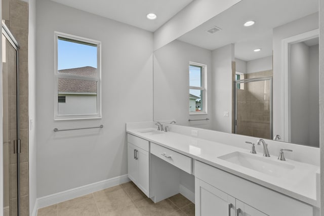 bathroom featuring vanity, a shower with shower door, and tile patterned floors